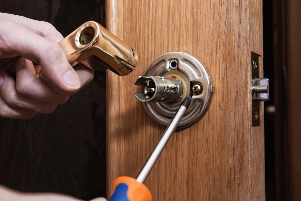 Emergency locksmith repairing a door lock mechanism in Sydney